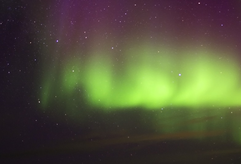 aurora-curtain Vertical magnetic rays rising into violet nitrogen glow.